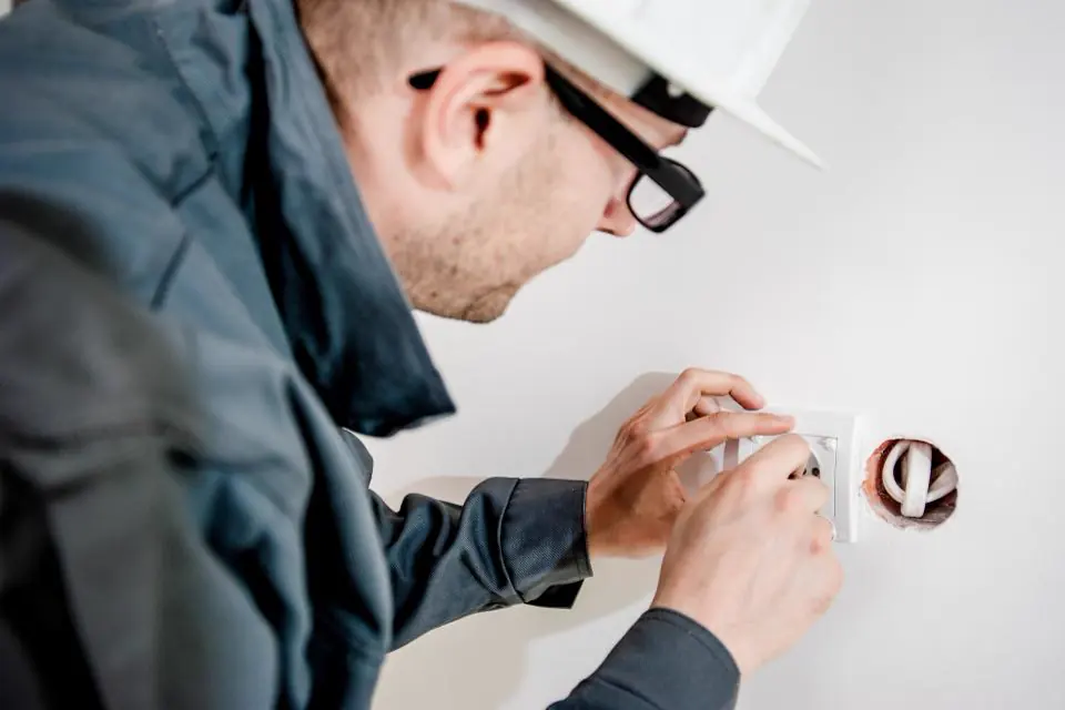 Electrician fitting a wall socket