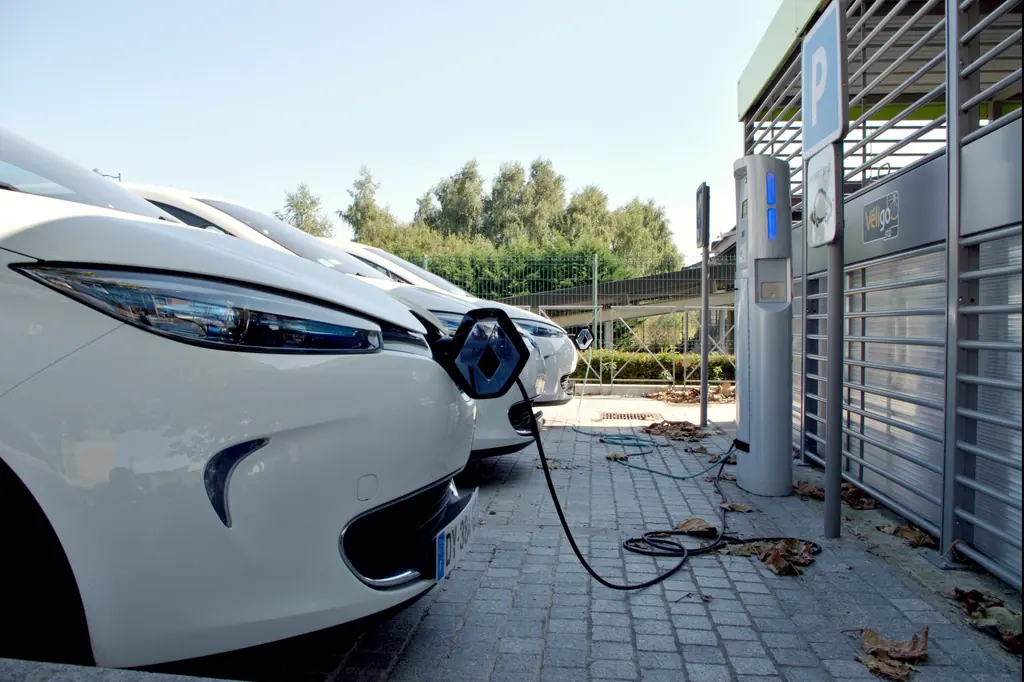 Electric cars plugged in at charging points